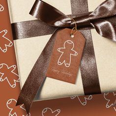 a gift wrapped in brown and white paper with a ginger on it's tag