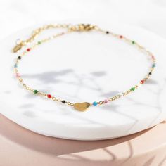 A beautiful muti coloured enamel bead anklet with heart detail. This bright and playful heart anklet is a must have accessory for Spring/Summer. Its beaded chain will add a pop of colour to any outfit and is sure to bring JOY on the ankle of the wearer. A lovely personalised gift or self indulgent treat. The item is presented on the sentiment card of your choice in a lovely organza gift bag, ready to give or keep. If you would like to upgrade your purchase to include a gift box please order here Trendy Colorful Beaded Anklets As Gift, Multicolor Beaded Chain Anklets As Gift, Trendy Multicolor Anklets As A Gift, Trendy Multicolor Anklets For Gift, Trendy Multicolor Anklets As Gift, Trendy Multicolor Heart Bracelet With Colorful Beads, Trendy Multicolor Beaded Heart Bracelet, Trendy Multicolor Heart Charm Bracelet, Trendy Heart Shaped Anklets For Gift