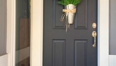 a potted plant is hanging on the front door to give it an inviting touch