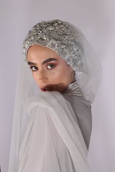 a woman wearing a veil with roses on it