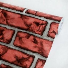 a red brick wallpaper with silver foiling on the top and bottom part of it