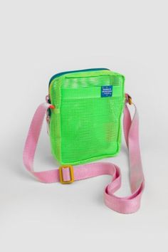 A great cross body style for everyday simple carrying with a hidden front pocket to easily access your phone! Features an adjustable strap that extends to 55" , front pocket, front hidden pocket, and back pocket. Double paracord side loops to hook on your keys. Content + Care Tear resistant 100% vinyl coated mesh Spot Clean Made in USA Size 7.5" tall x 5.5" wide x 3" deep, 1 lbs | Mokuyobi Mesh Sidekick Sling in Slime at Urban Outfitters Casual Mesh Bag For Everyday Use, Casual Travel Phone Bag, Casual Summer Phone Bag With Cell Phone Pocket, Sporty Shoulder Bag With Side Pockets For Everyday Use, Casual Nylon Rectangular Phone Bag, Casual Crossbody Phone Bag For School, Casual Rectangular Nylon Phone Bag, Nylon Phone Shoulder Bag, Everyday Nylon Phone Shoulder Bag