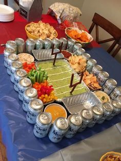 a table topped with lots of food on top of a blue cloth covered tablecloth