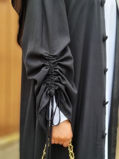 A soft and flowy, loose open abaya with pretty ruched sleeves. Simple & elegant. This abaya is sold in 4 different colours - Black, Pink, Brown and Cream. No belt is included. Buttons on the abaya are for display only Material: Polyester Sizes are based on length (S-52, M-53, L-55, XL-57 and XXL-59) and there may be 1-3 cm differences in the actual item. The hijab is not included. *Please note: Actual product colour may vary slightly due to individual monitor settings and picture quality enhance Black Abaya With Colour Hijab, Abaya Sleeves, Work Abaya, Trendy Abaya, Abaya Inspiration, Simple Abaya Designs, Long Skirt Top Designs, Black Abaya Designs, Simple Abaya