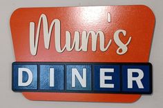 a red and blue sign that says mums diner on it's front wall