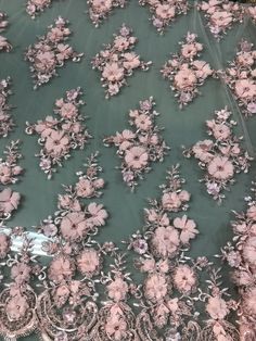 pink flowers on green sheer fabric with crystal beadings and sequins in the center