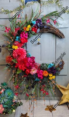 a wreath made out of fake flowers on a wooden wall next to a star and other decorations