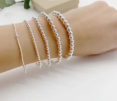 Sterling silver stretch bracelet beaded with Sterling silver 2mm,3mm,4mm, 5mm and 6mm beads. Great to wear alone or layered with other beaded bracelets. Bracelet measuring about 7inches with stretch. *Price is for one Bracelet. Add initials below  https://etsy.me/3IWjMIp All Jewelry is personalized and packaged in our small studio 🤍 * Order are shipped out 1-3 business days after the order as been received. If you need your order faster please upgrade at checkout * ** shipping ** All jewelry is packaged in anti tarnish plastic bags and neatly packed in a box or a gift bag and ready to gift. If you need extra gift boxes leave us a message at checkout ** Returns ** Returns can be made within 14 days of receiving your order. We will provide you with instructions on mailing your package back. Personalized Silver Bracelets, Goddaughter Gifts, Monogram Bracelet, Bracelet Initial, Minimalist Women, Custom Bracelet, Jewelry Personalized, Initial Bracelet, Custom Bracelets