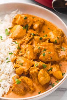 a white bowl filled with rice and chicken curry