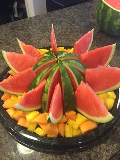 watermelon, melon and pineapple slices arranged on a platter