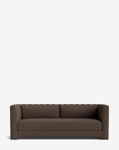 a brown couch against a white wall