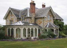 a large house with many windows in the front yard