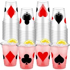 a set of four cups with playing cards and lemon slices on them, sitting next to each other