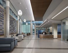 an office lobby with people sitting at desks