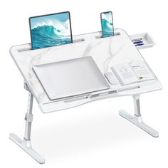 a white desk with two laptops on it and a phone in the holder next to it