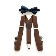 Suspender and bow tie for infants and toddlers 1x Navy bow tie 1x Brown suspenders ♥ Want to see more? Adult sizes also available! Full store: https://www.etsy.com/shop/crystalAmour For expedited shipping (delivers within 2-3 business days) Click here: http://etsy.me/1nH1bij All orders placed will be processed and shipped in 24-48 business via USPS. We ship all items out with excellent care and speedy shipping service. Domestic U.S. orders will receive their package within 3-7 business days once Adjustable Brown Bow Tie In Dapper Style, Adjustable Brown Belts And Suspenders With Bow, Navy Bow Tie, Brown Suspenders, Leather Suspenders, Blue Bow Tie, Baby Boy Clothing Sets, Brown Brown, Blue Bow