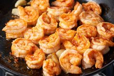 shrimp being cooked in a frying pan on the stove