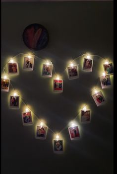 a heart made out of photos with lights strung from the sides and hanging on a wall