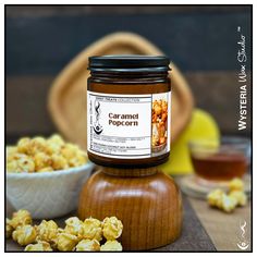 a jar of caramel popcorn sitting on top of a wooden table