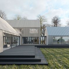 the house is surrounded by grass and has glass walls on both sides, with stairs leading up to it