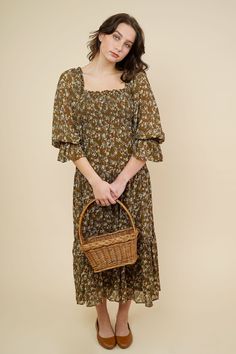 Romantic cottage core inspired midi dress in loose fit style. This dress comes in a cocoa brown that features a smocked bodice detailing with an allover mustard small flower print. Square ruffle neckline , 3/4 balloon sleeves with elastic cuffs. Slips on for wear Mother Friendly 100% Cotton Hand Wash Cold / Line Dry Measurements & Fit Notes Olivia and Rosa are both wearing a size Small Spring Peasant Dress With Smocked Cuffs, Brown Midi Dress With Smocked Bodice For Brunch, Brown Smocked Bodice Midi Dress For Brunch, Fall Brunch Midi Dress With Ditsy Floral Print, Spring Peasant Smocked Dress With Smocked Cuffs, Spring Brown Dress With Gathered Sleeves, Spring Brown Midi Dress With Square Neck, Spring Midi Dress With Square Neck In Brown, Brown Square Neck Midi Dress For Spring