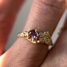 "This Juniper Cluster Ring features a shimmering purple, pear cut alexandrite set asymmetrically amongst a cluster of diamonds. The rustic and textured band is molded from an Ashe Juniper tree. 100% recycled gold  100% lab grown diamond & alexandrite Every single ring in my collection is designed, sculpted and produced entirely by hand. I never use computers and I never use \"off-the-shelf\" designs that you see in so many jewelry stores. Each ring begins by casting an actual twig or piece of ba Asymmetrical Gold Ring, Unique Engagement Rings Art Deco, Bee Engagement Ring, Fairy Style Engagement Ring, Vintage Ring Engagement, Freeform Engagement Rings, Organic Gold Engagement Ring, Eclectic Rings Engagement, Irregular Engagement Ring