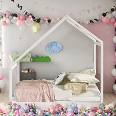 a room with balloons and a bed in it