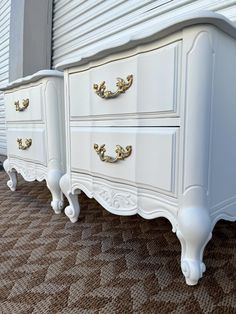 two white dressers sitting next to each other on top of a carpeted floor