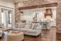 a living room filled with furniture next to a kitchen