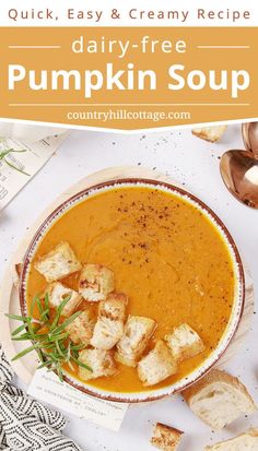 a bowl of pumpkin soup with croutons on the side and an orange napkin next to it