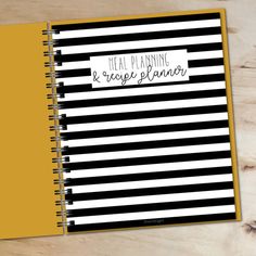 a black and white striped notebook with the words meal planning and recipe planner written on it