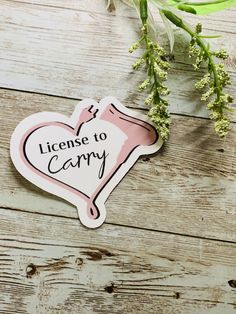 a sticker with the words license to carry on it next to some baby's breath flowers