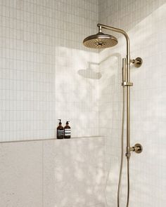 a shower head with thermostaer and soap dispenser on it