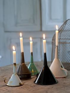 five candles are sitting on a wooden table