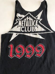 This was a men's Metallica Fan Club tee that was reworked into a small women's tank. It's one of a kind. There is a rip in the lower front that was used to tie the bottom of the shirt with. I've provided measurements in the photos for an accurate fit. It's the perfect true vintage Metallica fan tee to partner with your trashed hi rise 90's jeans and your docs. And it's already reworked and custom cut ⚡️ (14) Edgy Streetwear Tank Top With Letter Print, 90s Letter Print Tank Top For Streetwear, Edgy Graphic Print Muscle Tee For Streetwear, Edgy Racerback Top For Streetwear, Band Merch Crew Neck Tank Top With Letter Print, Punk Crew Neck Tank Top For Concerts, Punk Style Crew Neck Tank Top For Concerts, 90s Band Logo Tops For Fan Merchandise, 90s Letter Print Tops For Music Festivals