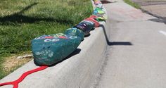 the skateboarders are lined up on the curb to ride down the hill together