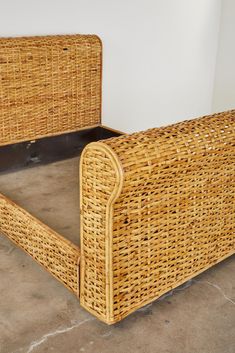 a wicker bed frame sitting on the floor