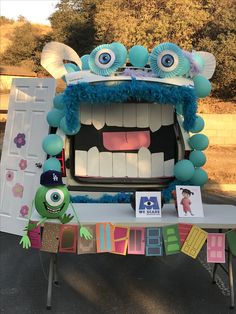 a table with some decorations on it and an odd looking monster head in the center