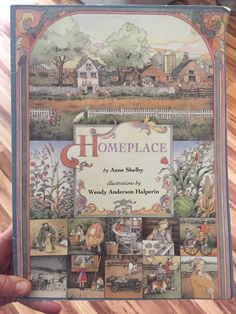 someone holding up a book about homeplace