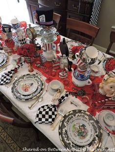 the table is set with many plates and silverware