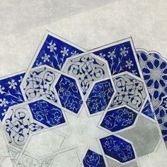 blue and white art work with flowers on the bottom, surrounded by hexagonal shapes