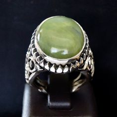 925 STERLING SILVER MEN'S RING WITH GREEN JADE Handcrafted by Turkish artisan jewelers Sterling Silver - unique design Gemstone: natural green Jade origin: Brazil Stone Dimensions: 18x25x5mm weight: 13ct Size: US10.25 *for resizing request feel free to contact. Worldwide express delivery Green Large Stone Ring Jewelry, Green Large Stone Ring, Artisan Green Jewelry With Large Stone, Handmade Green Jade Rings, Green Sterling Silver Spiritual Rings, Green Oval Ring With Large Stone, Green Oval Rings With Large Stone, Green Emerald Ring In Sterling Silver, Oval Green Ring With Large Stone