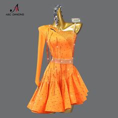 a mannequin wearing an orange dress with sequins on the bottom and sides