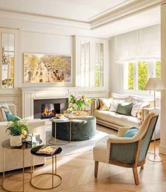 a living room filled with furniture and a fire place in the middle of a room