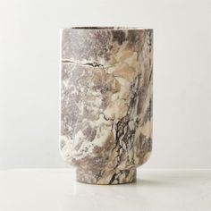 a marble vase sitting on top of a white table