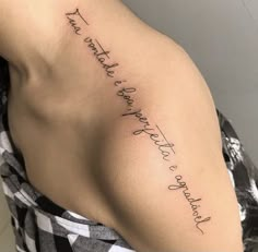 the back of a woman's shoulder with writing on it