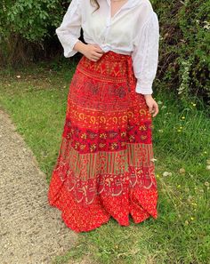 "Vintage 1970s Red Batik Print Wrap Maxi Skirt. So lovely and pretty! Thick cotton fabric. Really pretty batik block print pattern. Wraps around and ties up on one side with a tie.  Would fit around UK size 8-12 Skirt Measurements - Bust: 36\" Waist: 31\" Hips: 36\" Length: 40\" shown on size 10/12 5ft 4\" model How to Care: Hand Wash When you unpack your order, hang it up and let it relax to let the creases drop out, either steam it or gentle press on the reverse side of the garment with a warm Red Bohemian Cotton Skirt, Bohemian Red Cotton Skirt, Bohemian Cotton Skirt With Batik Print, Block Print Pattern, Skirt Measurements, Batik Print, Wrap Maxi Skirt, Batik Prints, Brown Dress