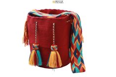 a large red basket with tassels on it