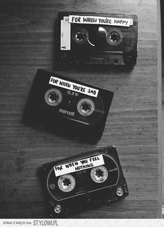 an old fashioned cassette player sitting on top of a wooden table next to a tape recorder