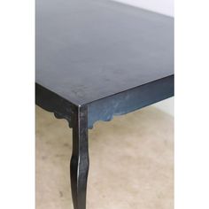 a black table sitting on top of a tile floor